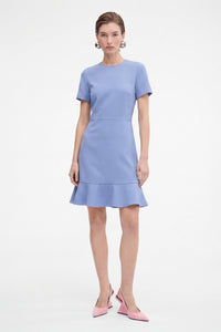 Lavender flounce hem dress, front view, worn by model, paired with pink heels.