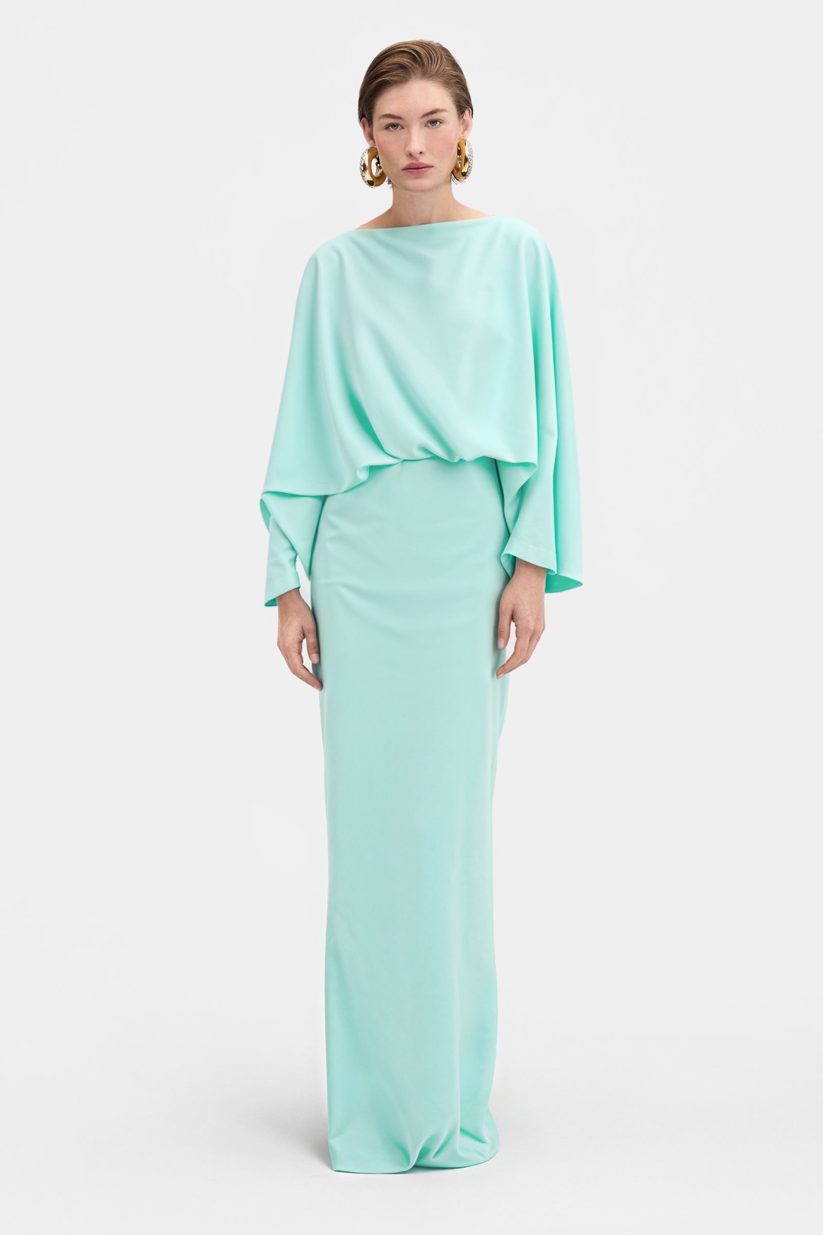 Elegant green draped dress with sculptural top and flowing maxi skirt front view