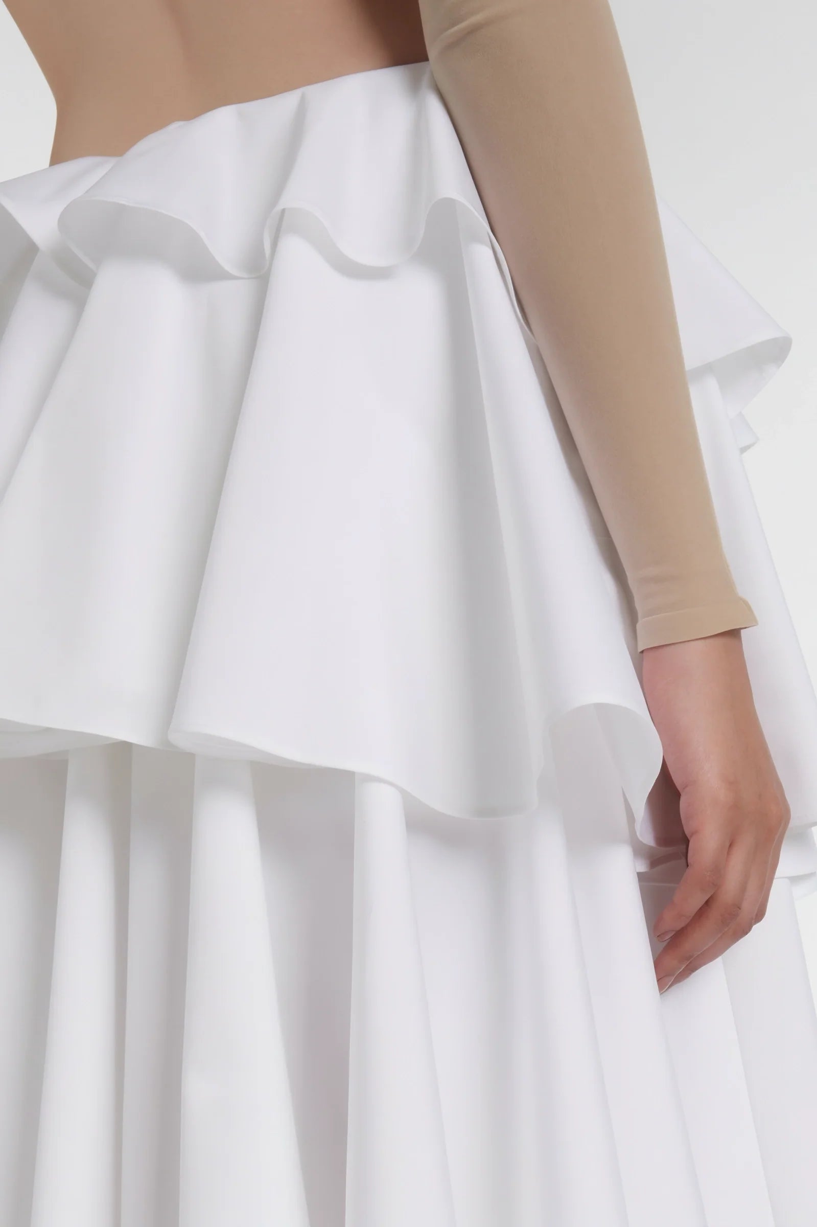 Close-up of cotton poplin texture and ruffled hem detail in white
