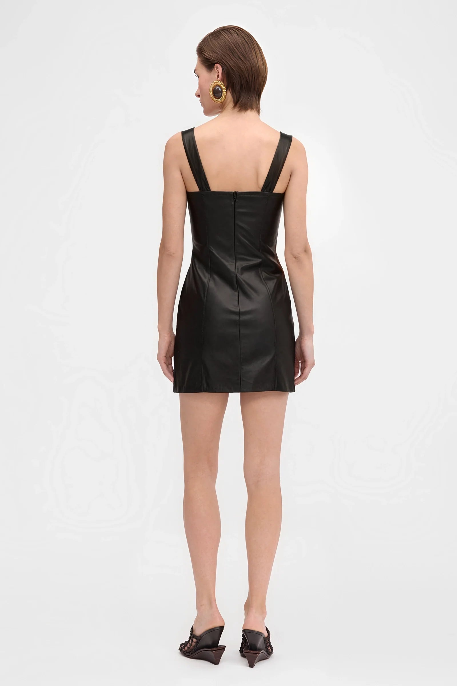 Full body look of black leather asymmetric mini dress