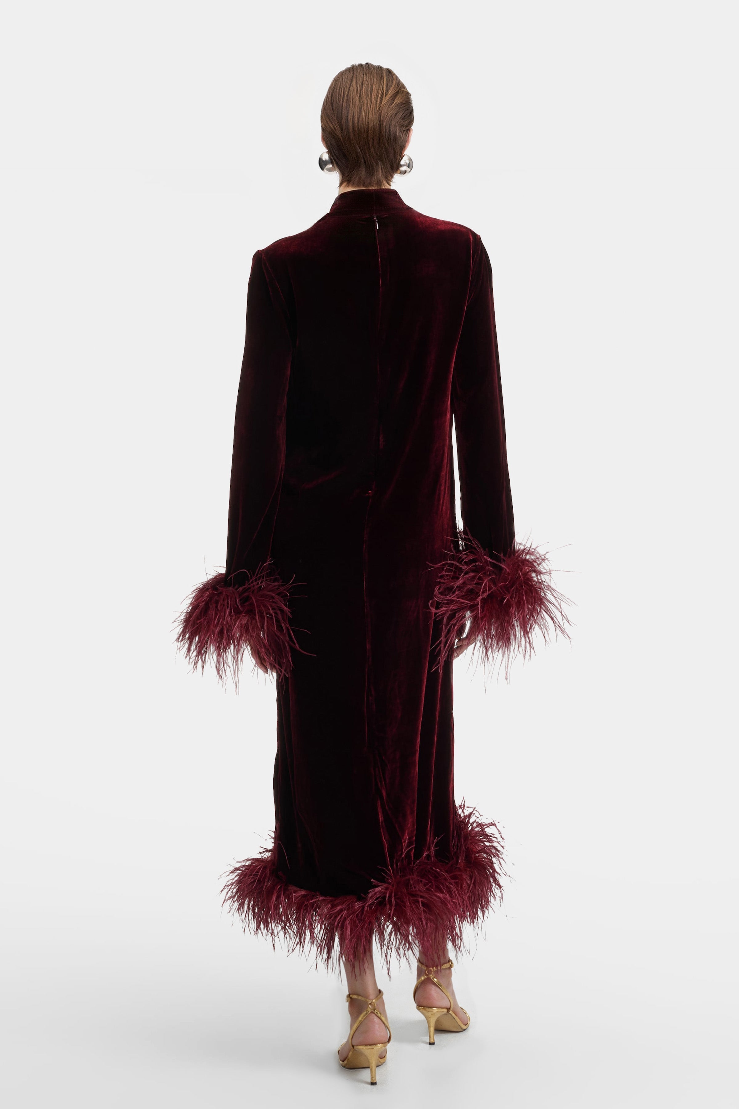 Rear view of the Aura Velvet Feather dress featuring a high neck and tailored silhouette in stretch velvet
