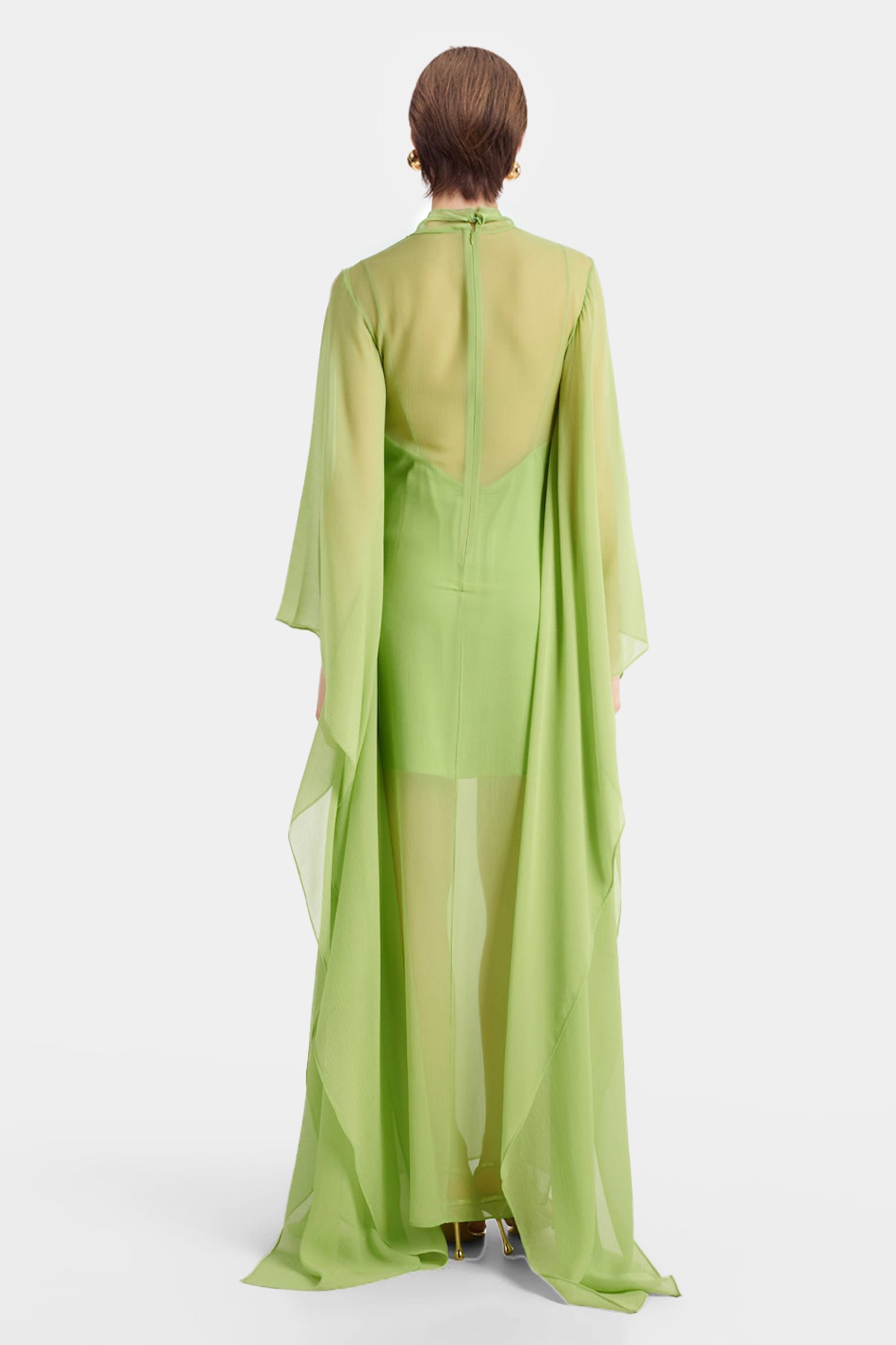 Back view of lime green chiffon evening gown with dramatic cape overlay