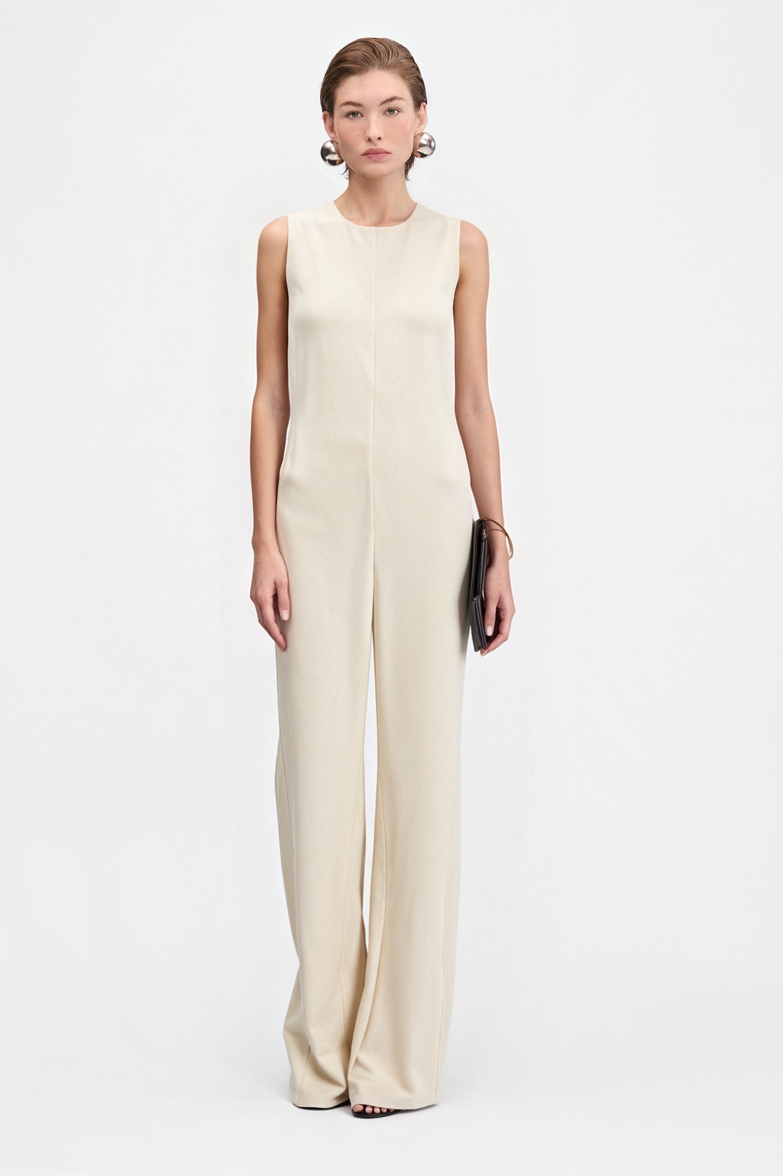 Front view of sleeveless cream crepe jumpsuit with wide-leg silhouette