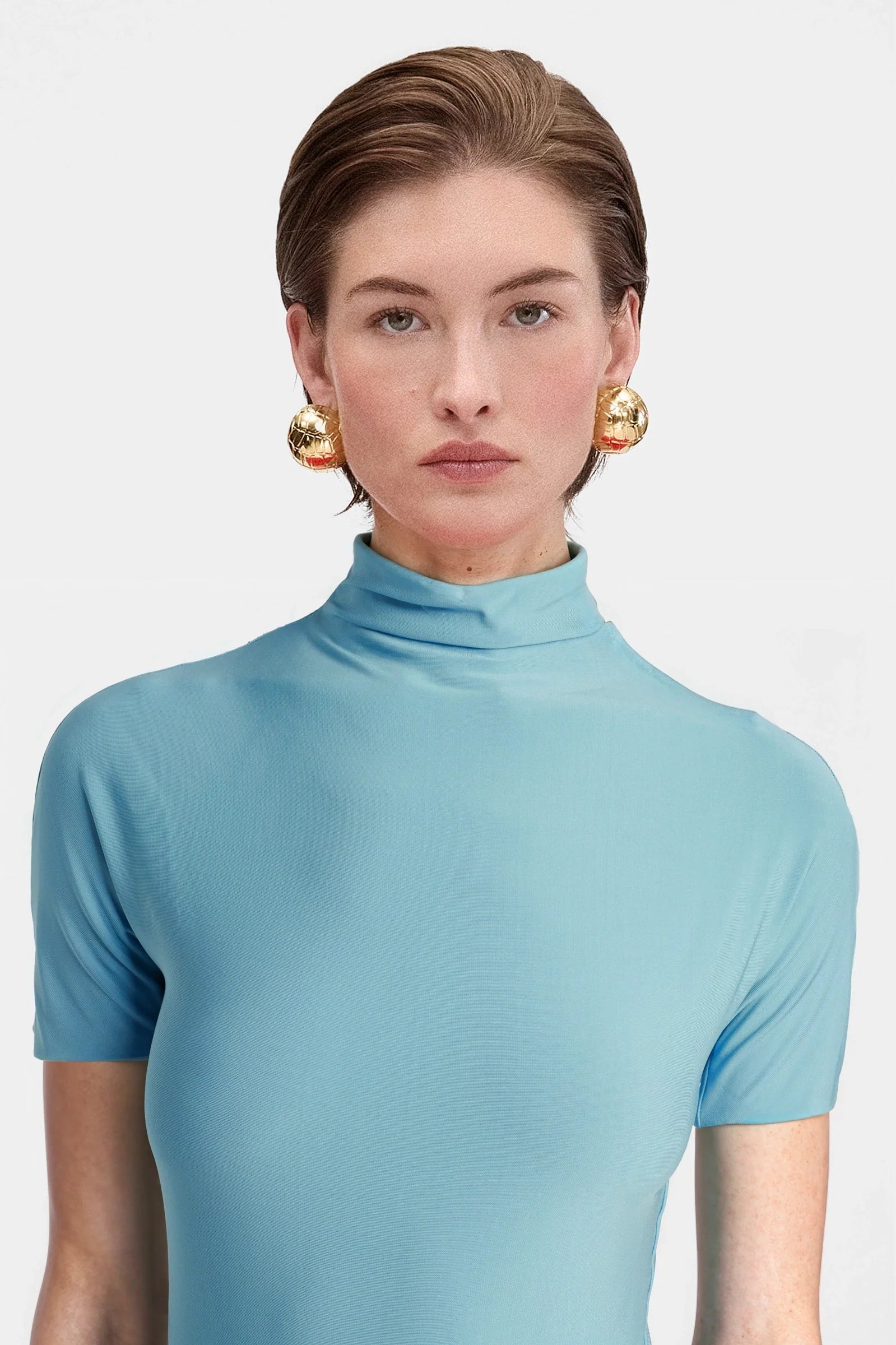 Close-up of the intricate ruched detailing on the midsection of the cyan draped jersey maxi dress, highlighting the texture and gathering.