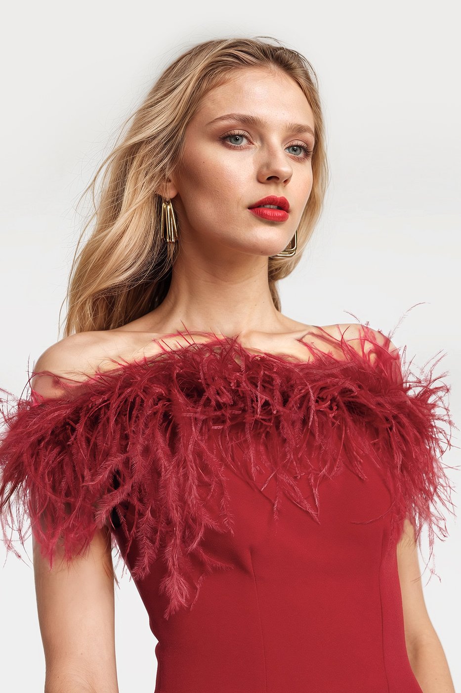 Chic red midi dresses featuring a feather trim and stylish slits in the back.