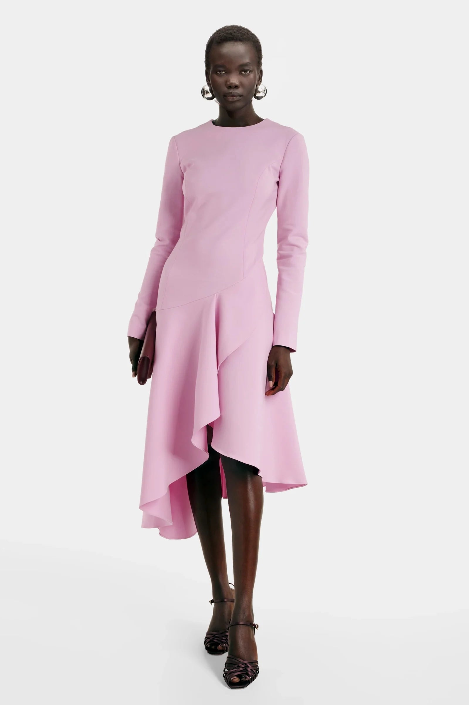 Model wearing asymmetric pink ruffle midi dress by Felipe Albernaz
