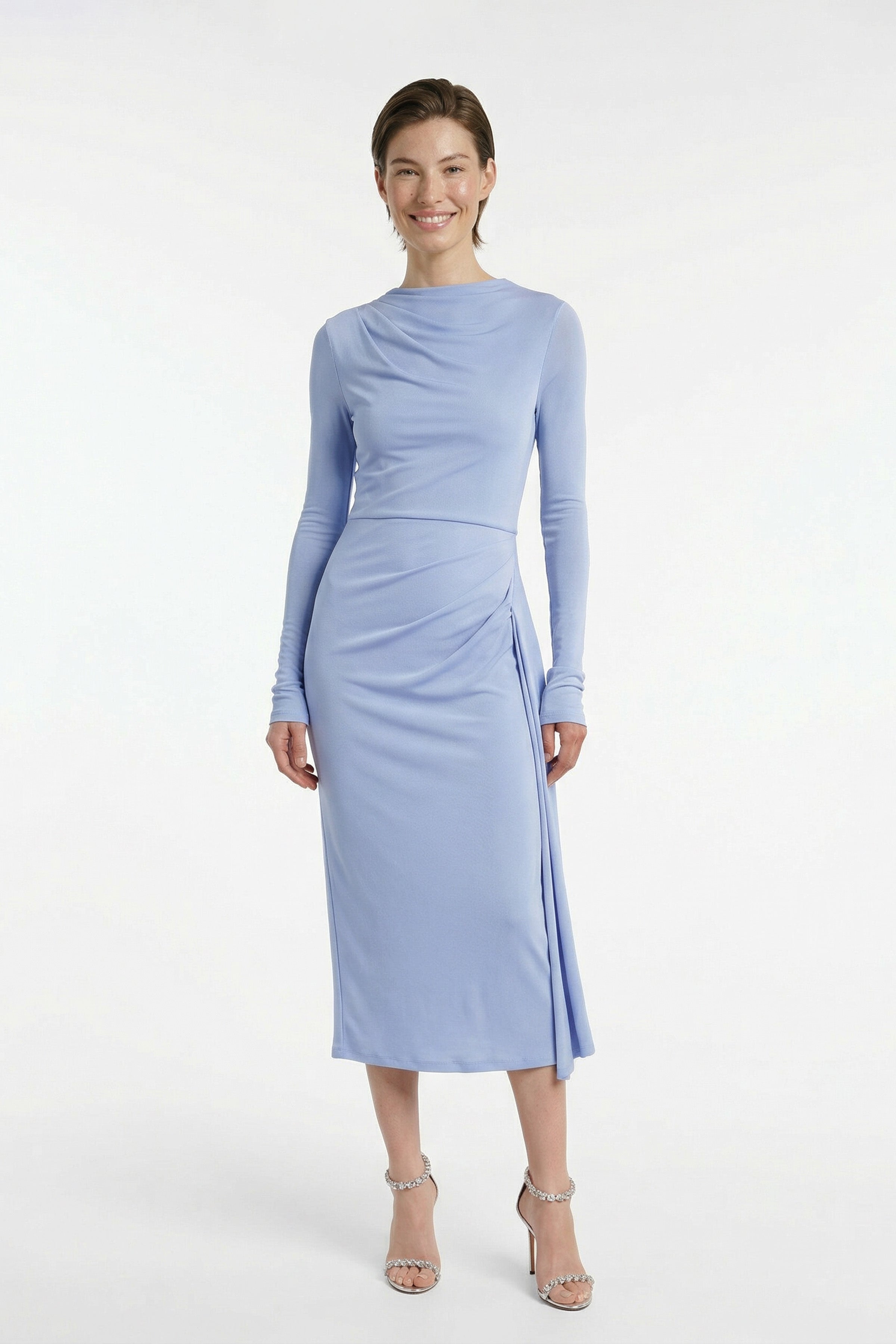 Model wearing sky blue draped midi dress, long sleeves, front view, slight smile.