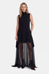 Black sheer overlay dress with high-low hem, sleeveless, model wearing burgundy ankle boots.
