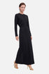 Model wearing black long sleeve maxi dress, front view, gold heels, minimalistic style.