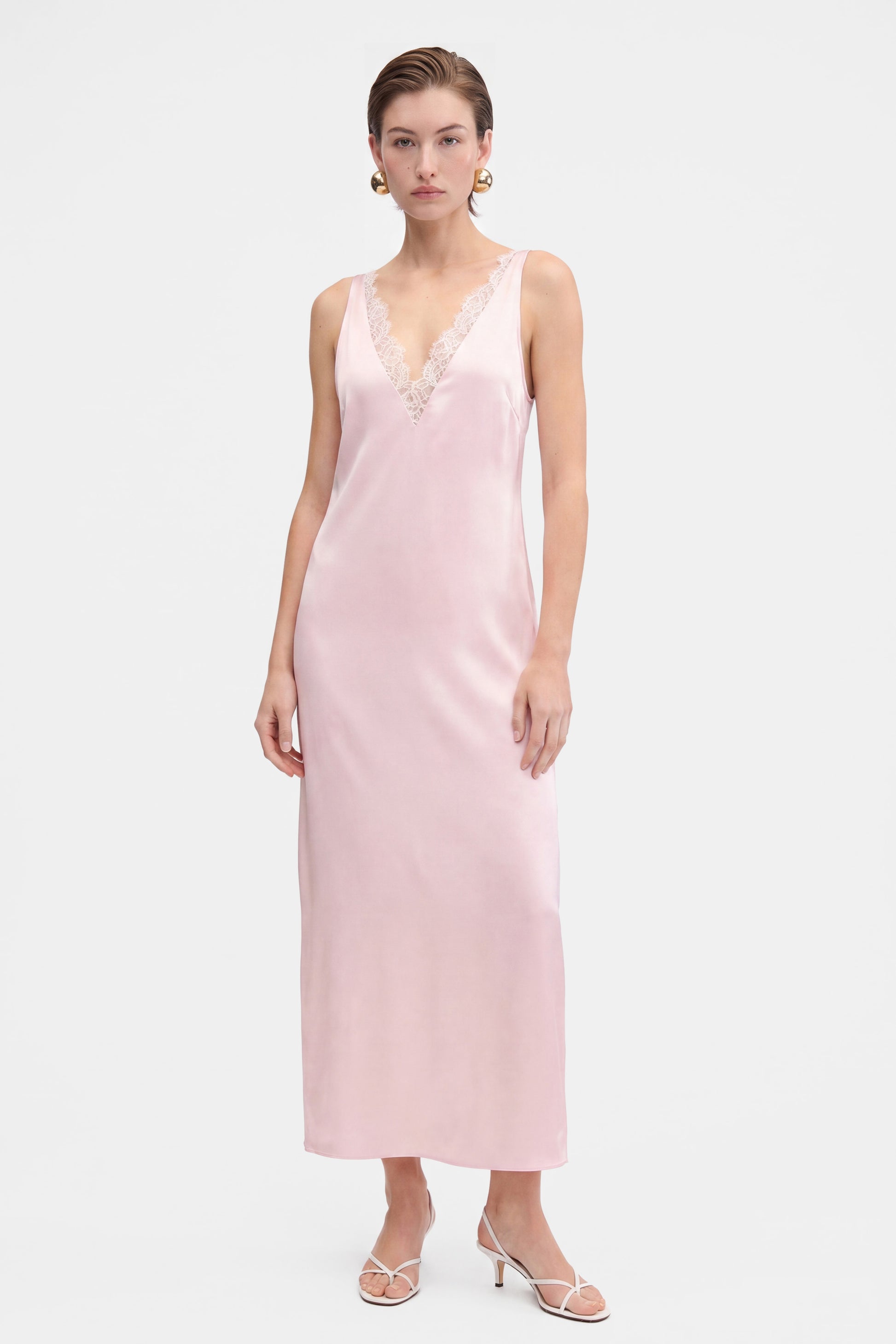 Blush lace slip dress, front view, lace detail, model wearing heels.