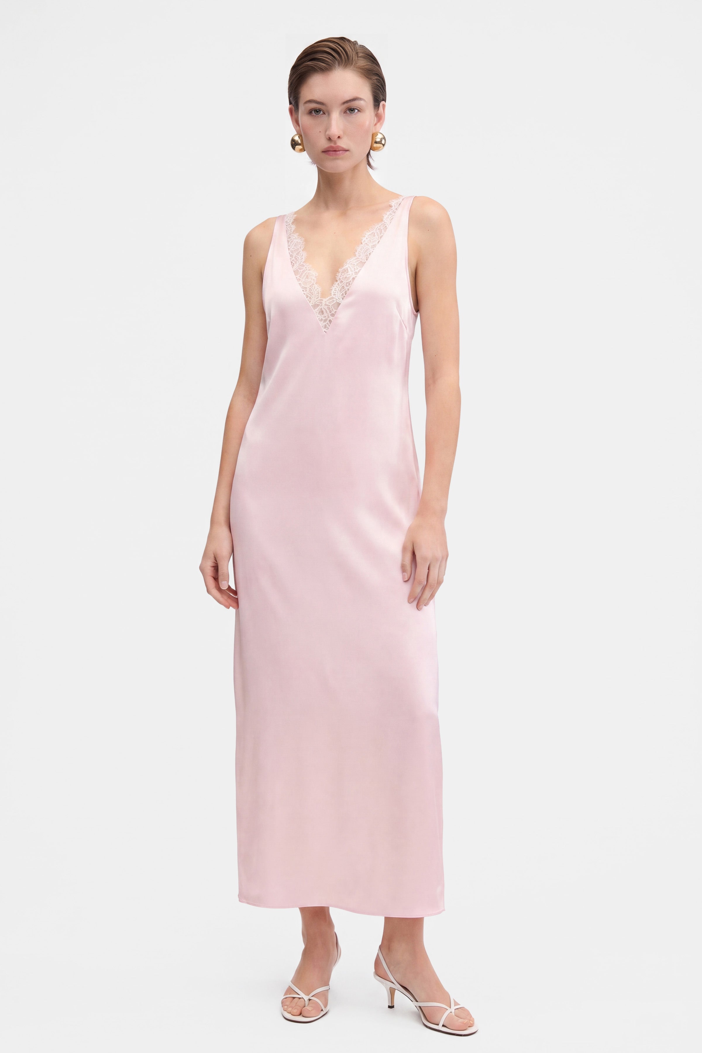 Blush lace slip dress, front view, lace detail, model wearing heels.