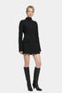 Model wearing black tailored mini dress, front view, paired with tall black boots.