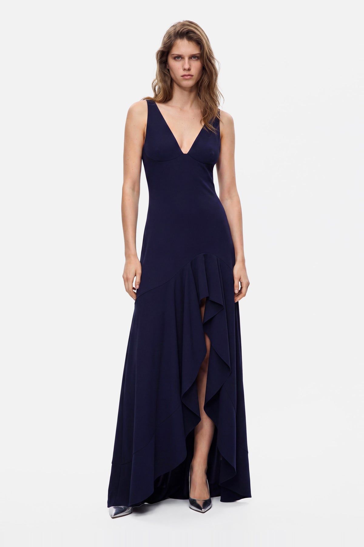 Navy ruffle hem gown, front view, sleeveless, V-neckline, floor-length, model standing.