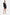 Model in black tuxedo mini dress, deep neckline, gold heels, elegant pose.