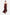 Model wearing burgundy strapless gown, thigh-high slit, flowing front view, gold sandals.