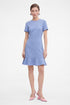 Lavender flounce hem dress, front view, worn by model, paired with pink heels.