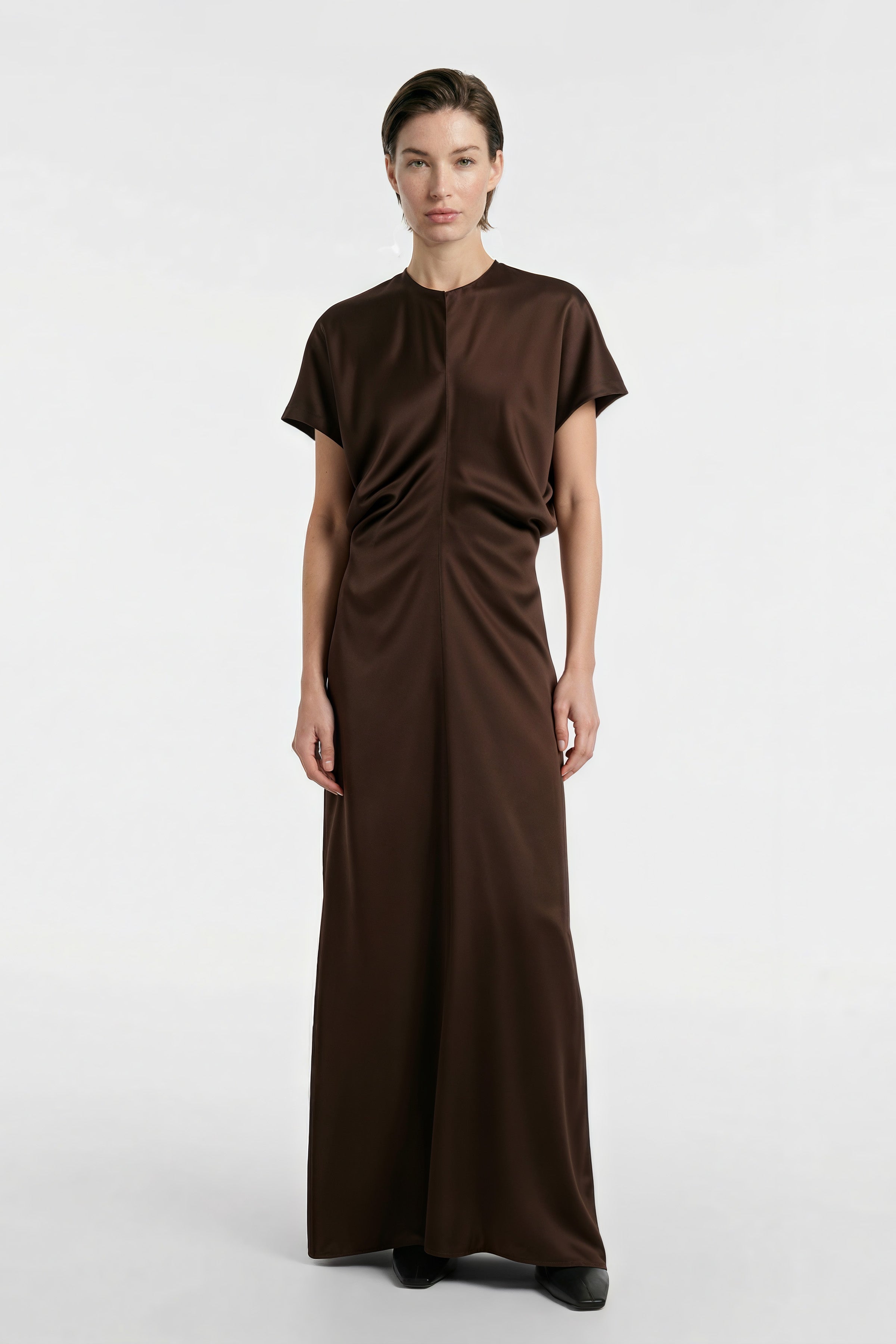 Model wearing Chocolate Satin Maxi Dress, front view, short sleeves, floor-length.