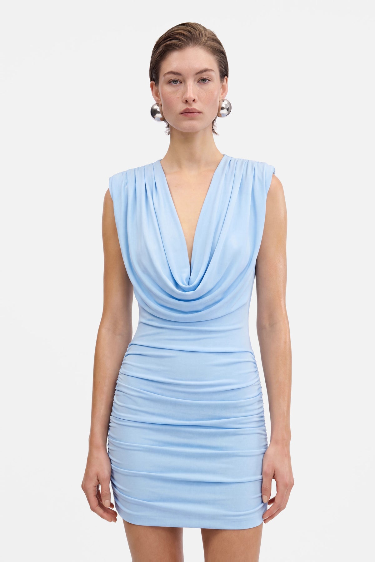 Sky blue mini dress, draped neckline, ruched, model front view, elegant style.