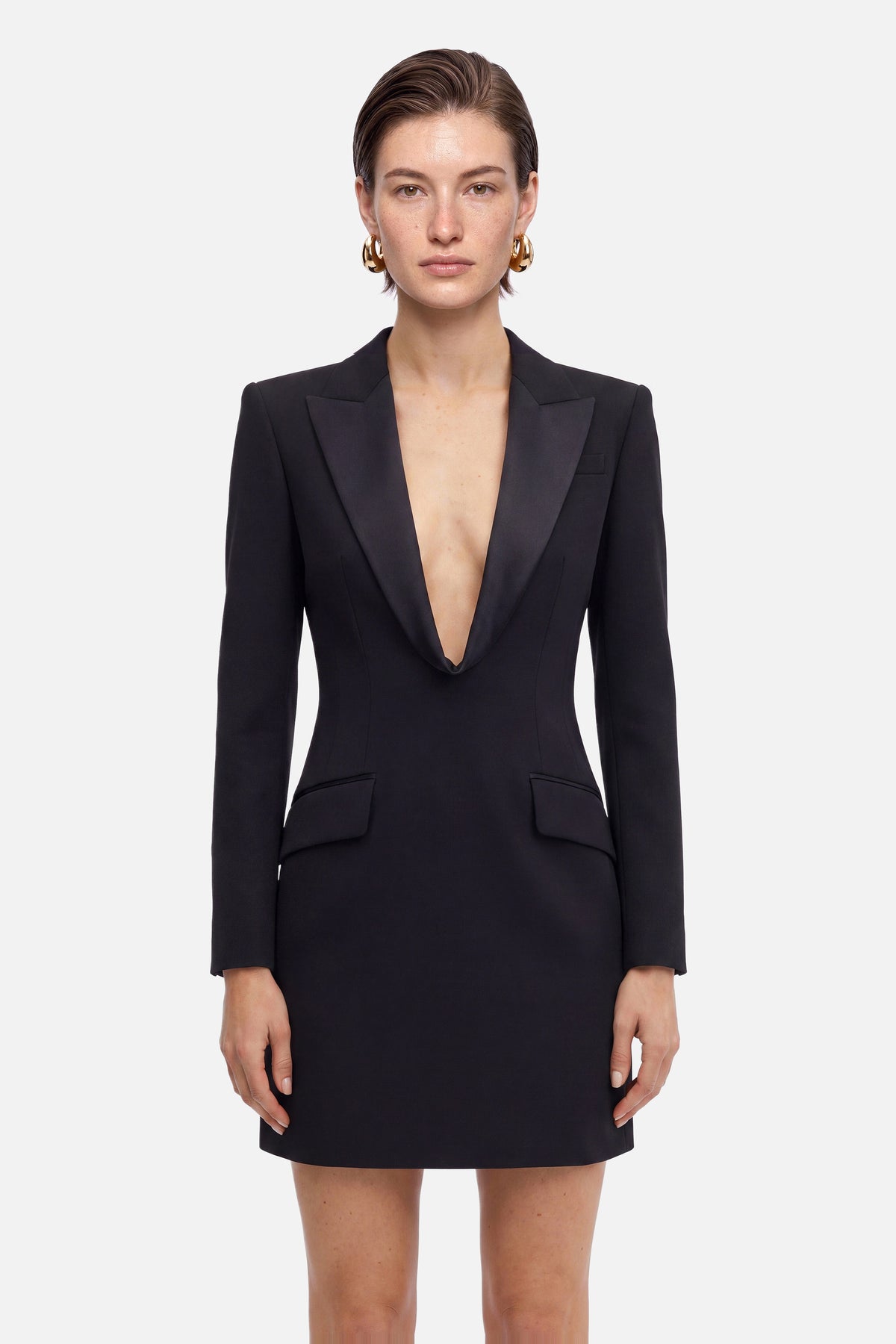 Front view of black tuxedo mini dress with deep V-neck and structured shoulders.