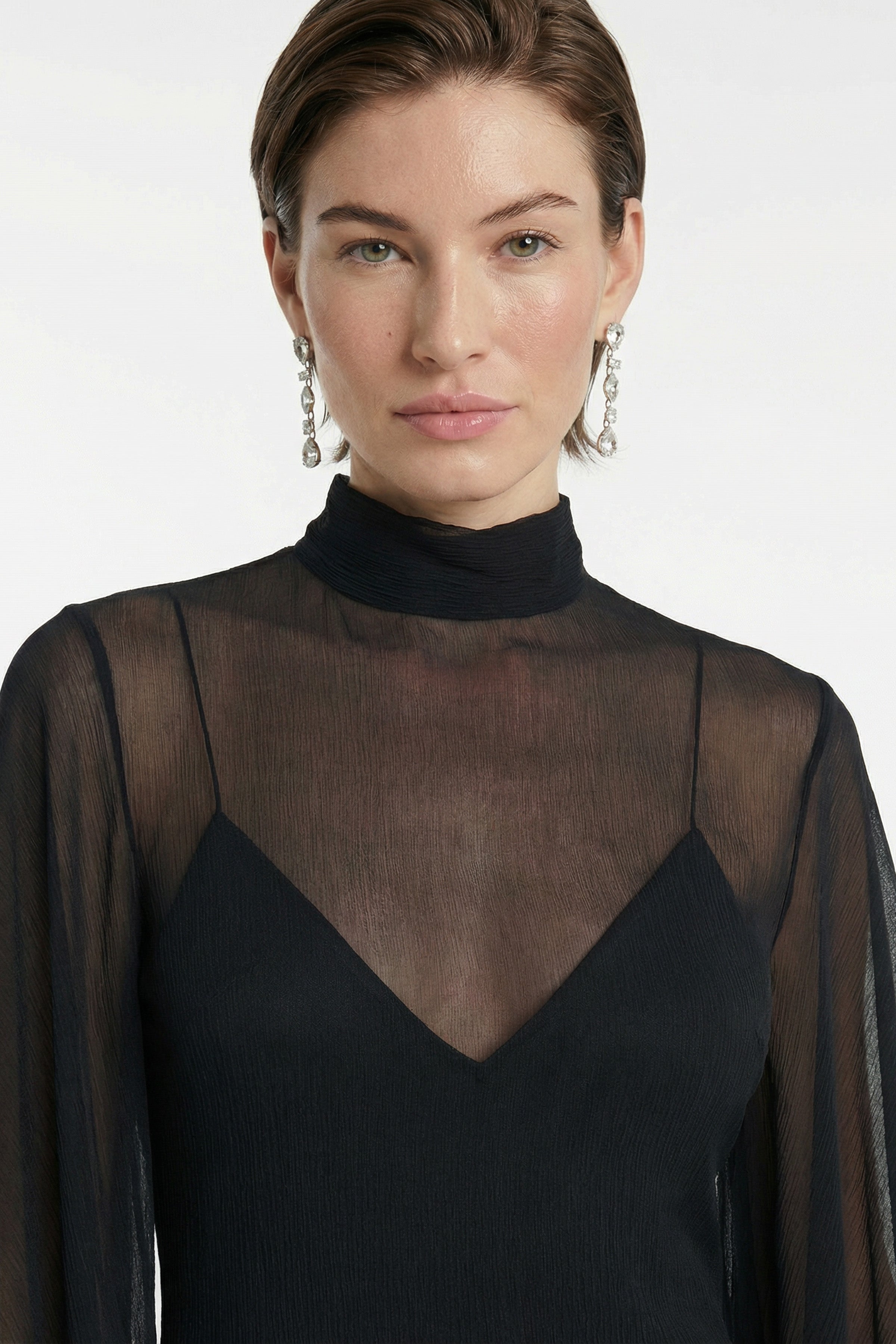Close-up of sheer chiffon fabric texture on black gown