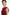 Front view, model in ruffled scarlet mini dress with elegant shoulder detail.