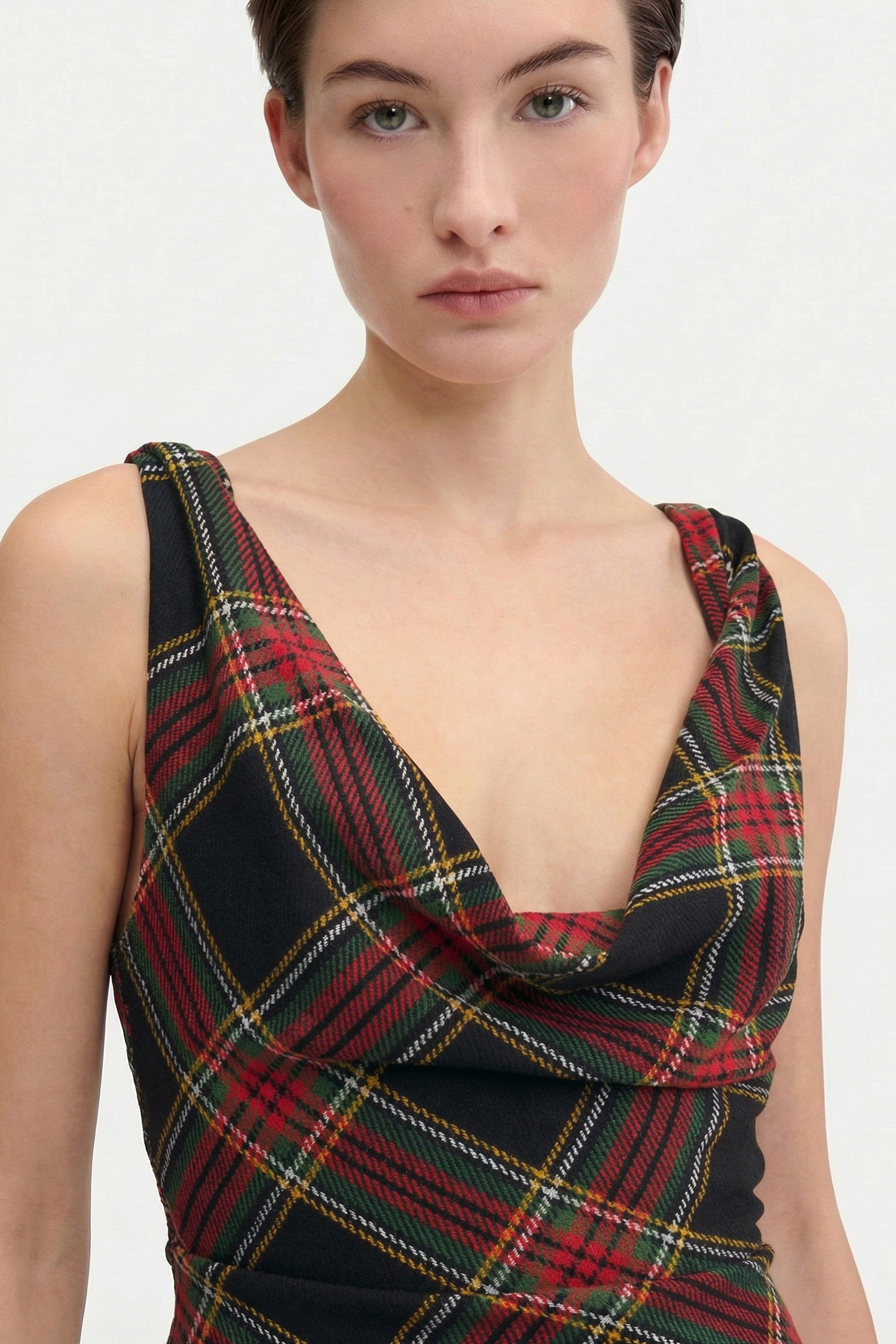 Front view of tartan mini dress with draped neckline.