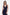 Front view of navy gown with ruffle hem, deep V-neckline, worn by model.