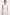 Front view of a white halter midi dress on a model with golden earrings.