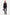 Model in tailored black suit, front view, holding brown handbag, wearing heels.