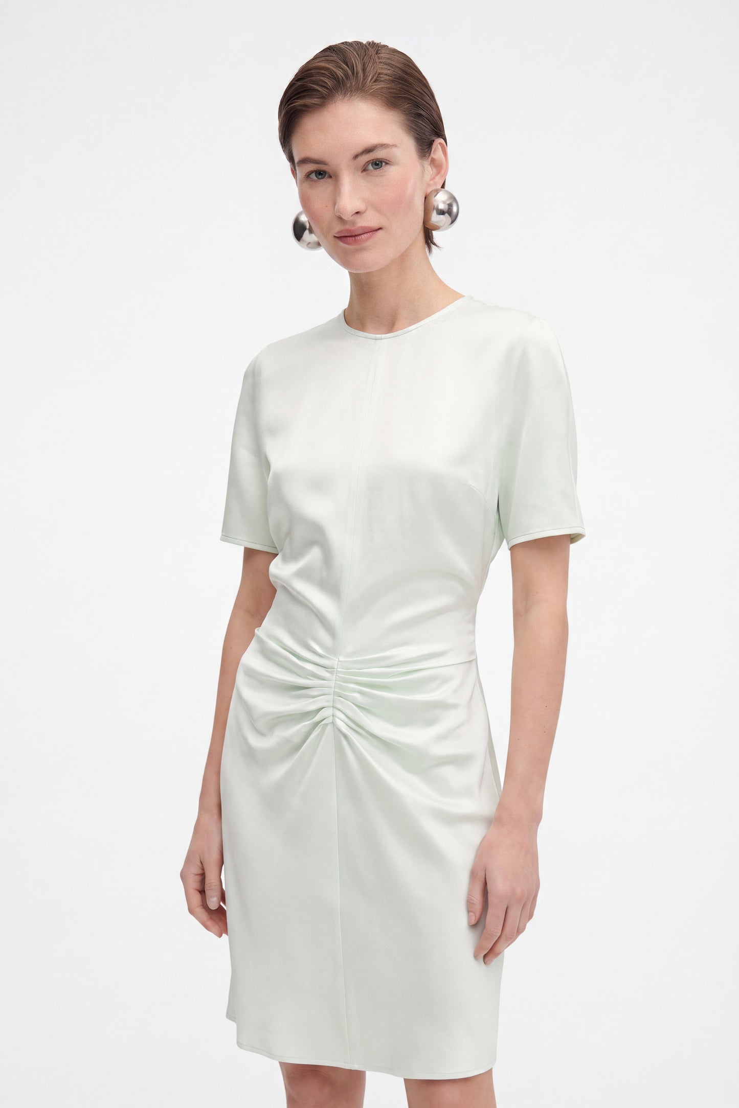 Front view of mint ruched satin dress on model, showcasing elegant details.