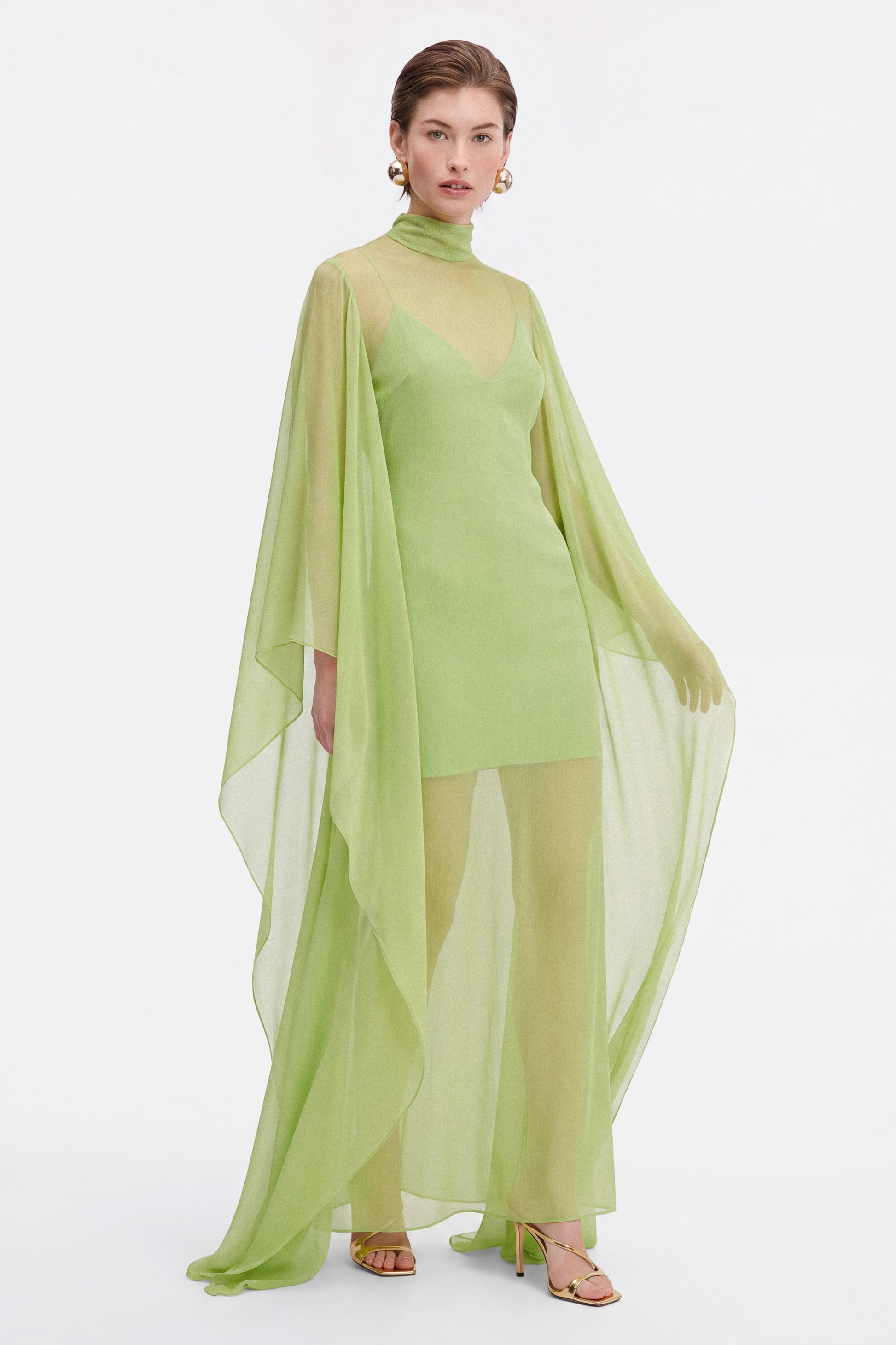 Model moving a chiffon cocktail dress, the cape make a beautiful movement 
