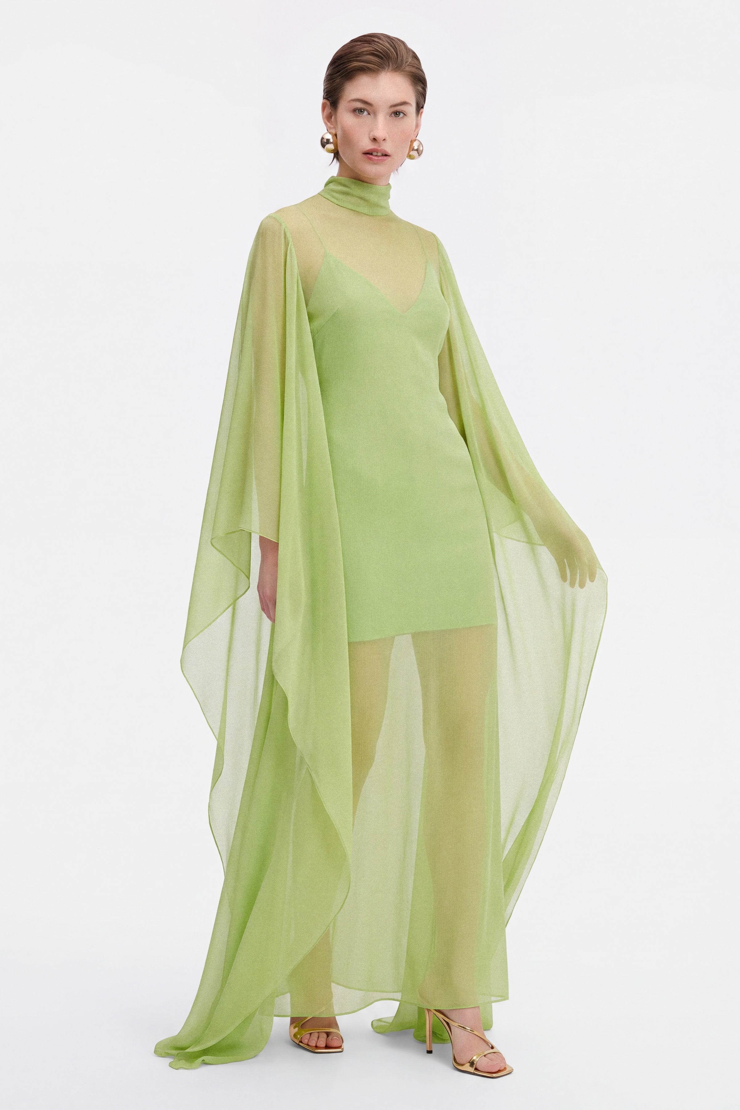 Model moving a chiffon cocktail dress, the cape make a beautiful movement 