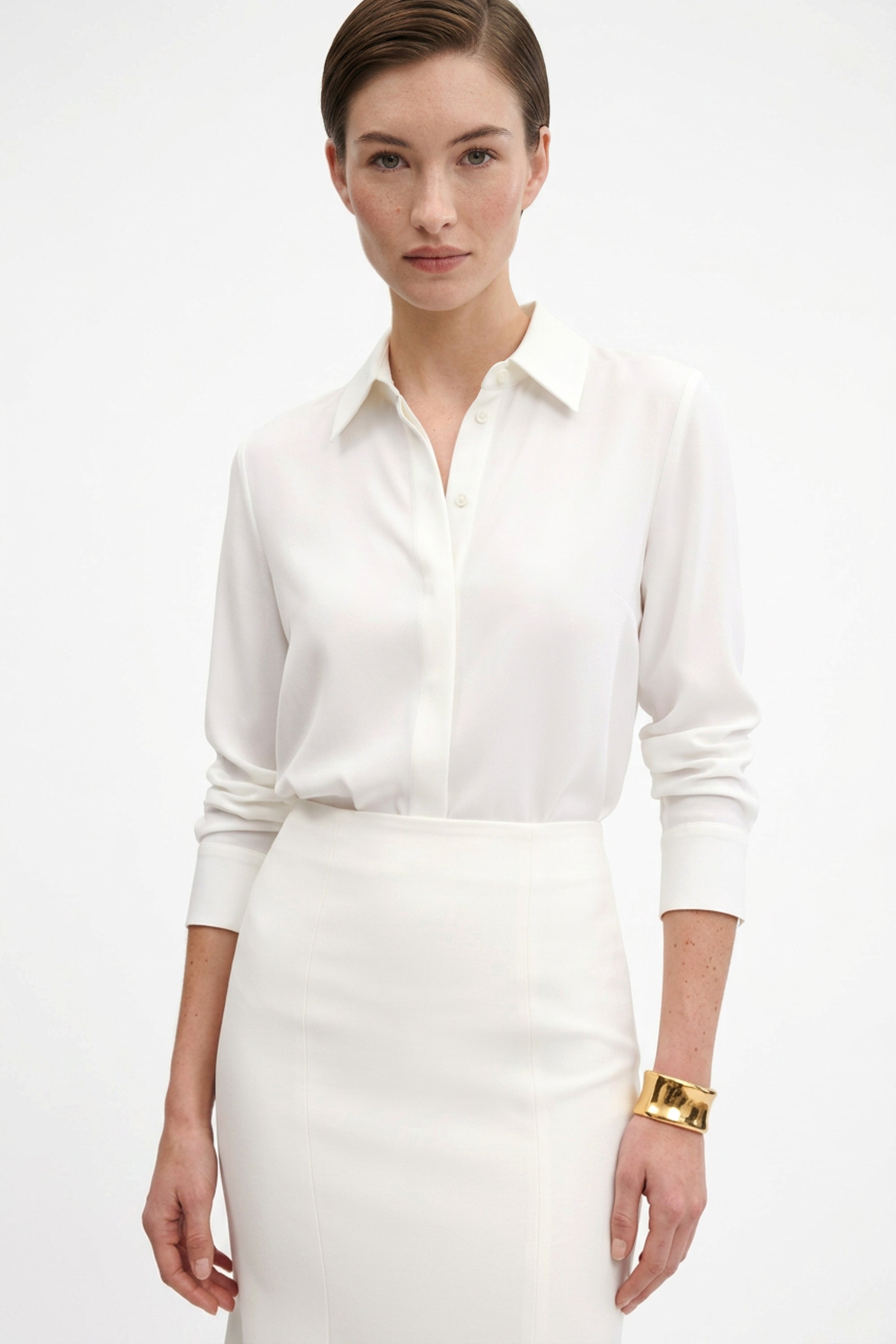 Ivory midi skirt front view with collared shirt and gold bracelet detail.