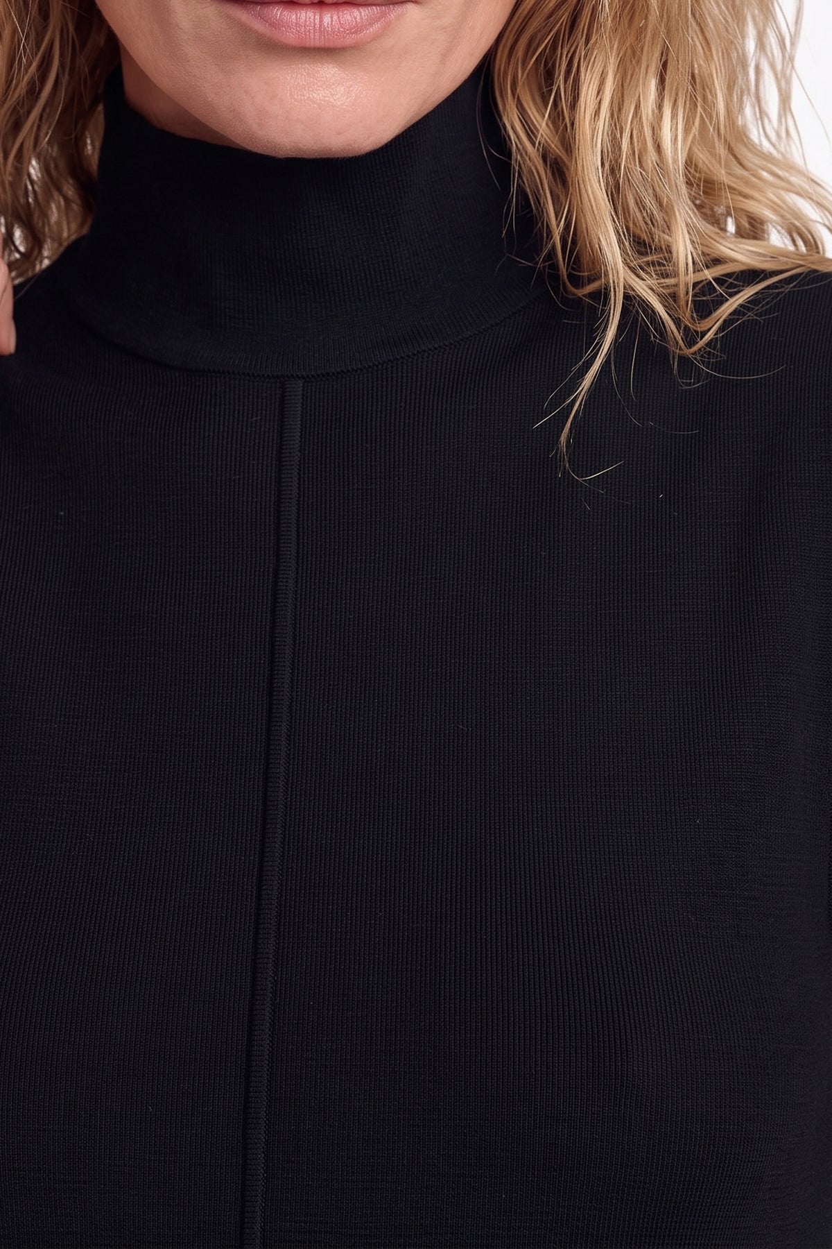 Close-up of black sheer overlay dress's ribbed texture and high neckline.