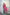 Model wearing elegant fuchsia midi dress, front view, leaning against stone wall.