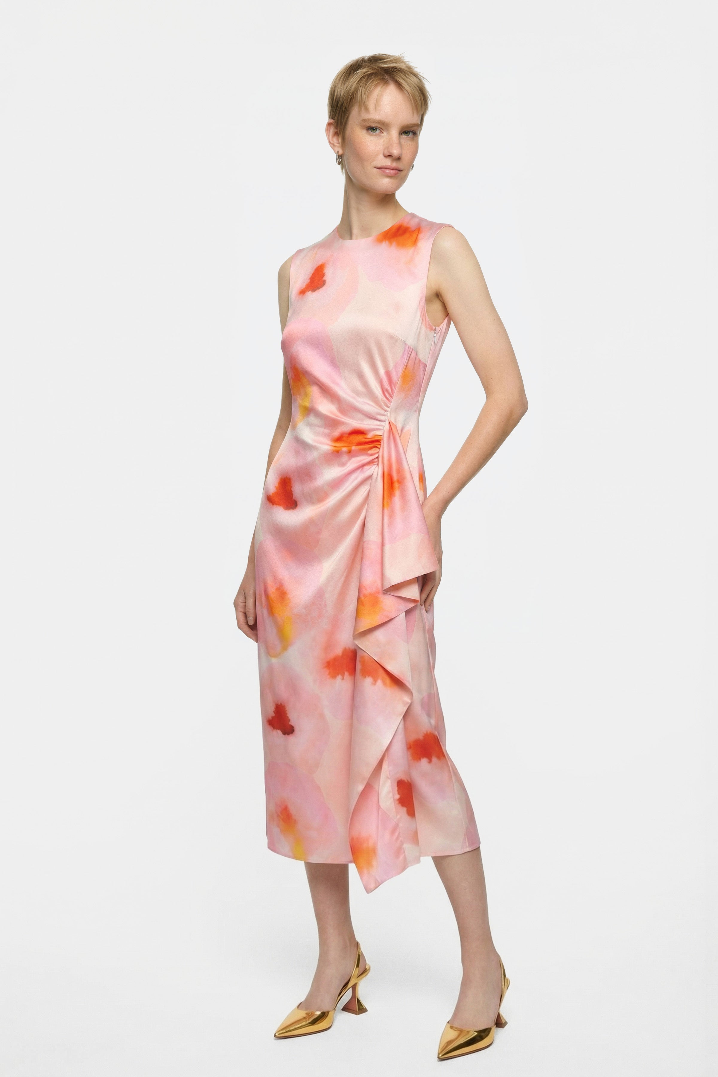 Front view of sleeveless watercolor print midi dress with draped waist detail.