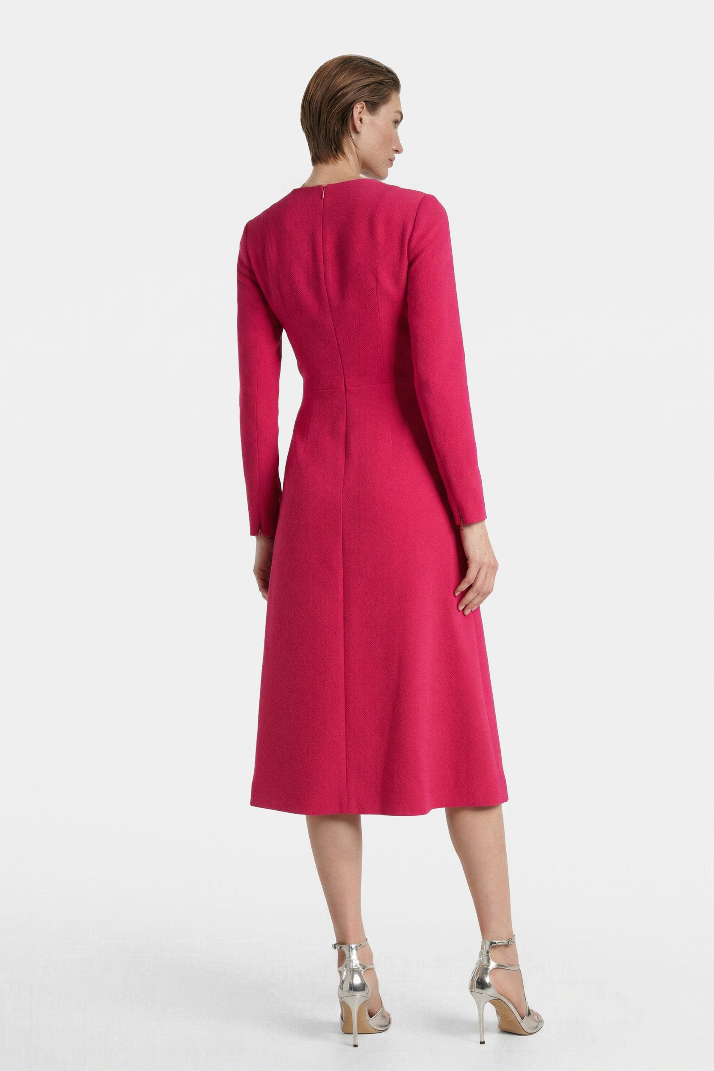 Back view of elegant fuchsia midi dress on model, showcasing sleek silhouette.