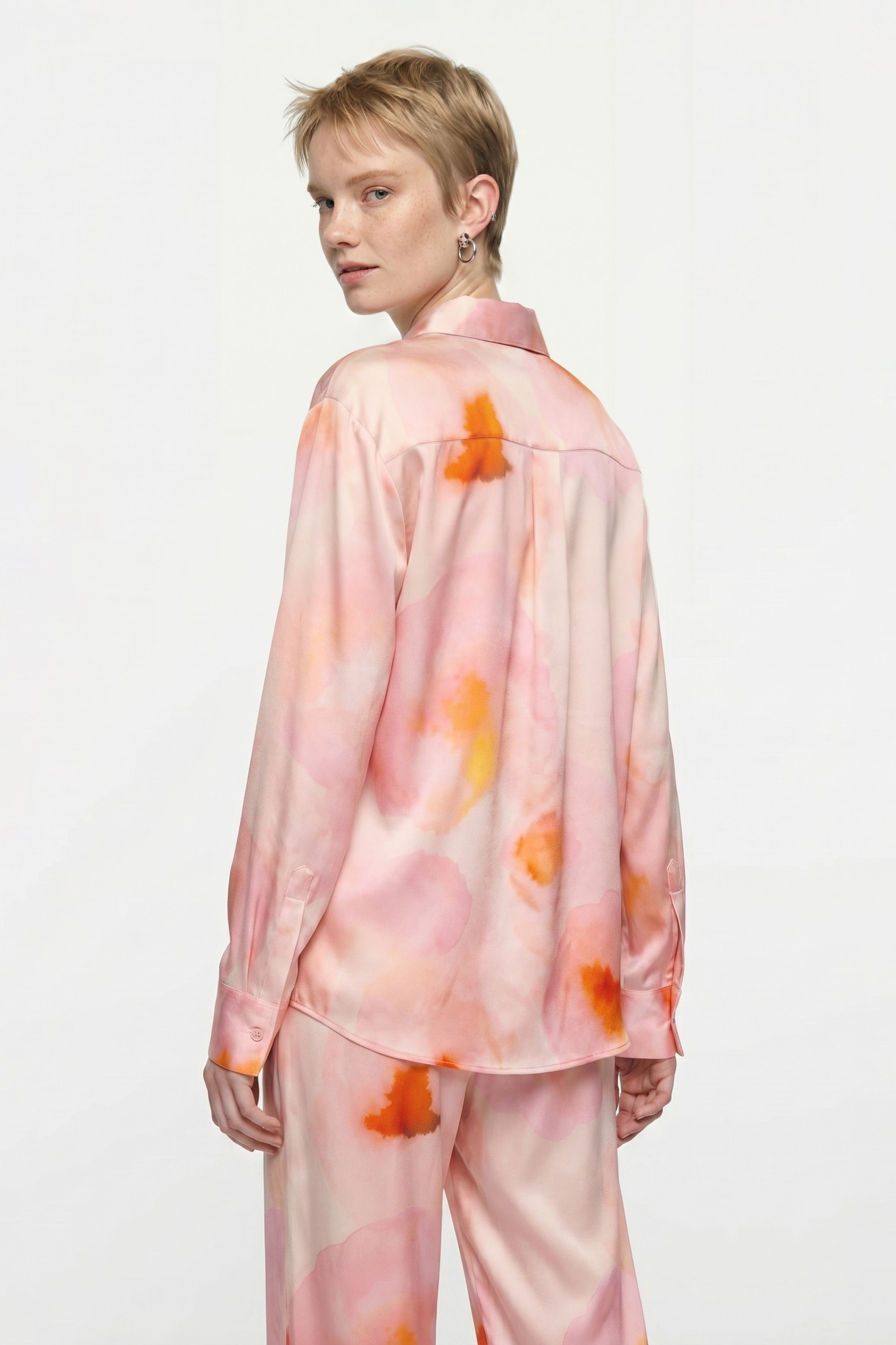 Model wearing Watercolor Silk Set, back view, light pink and orange pattern.