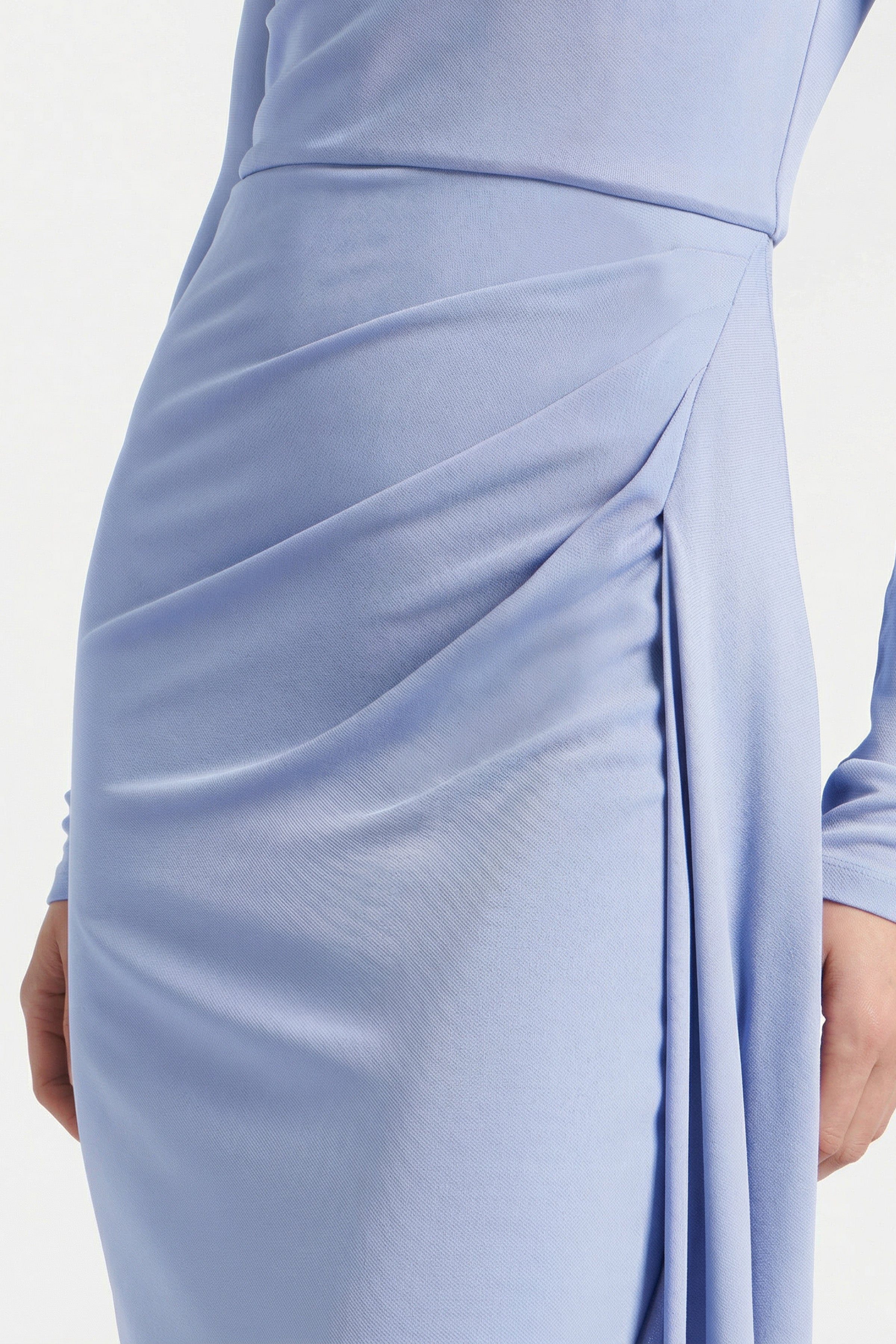 Close-up of sky blue draped midi dress fabric detail on model.