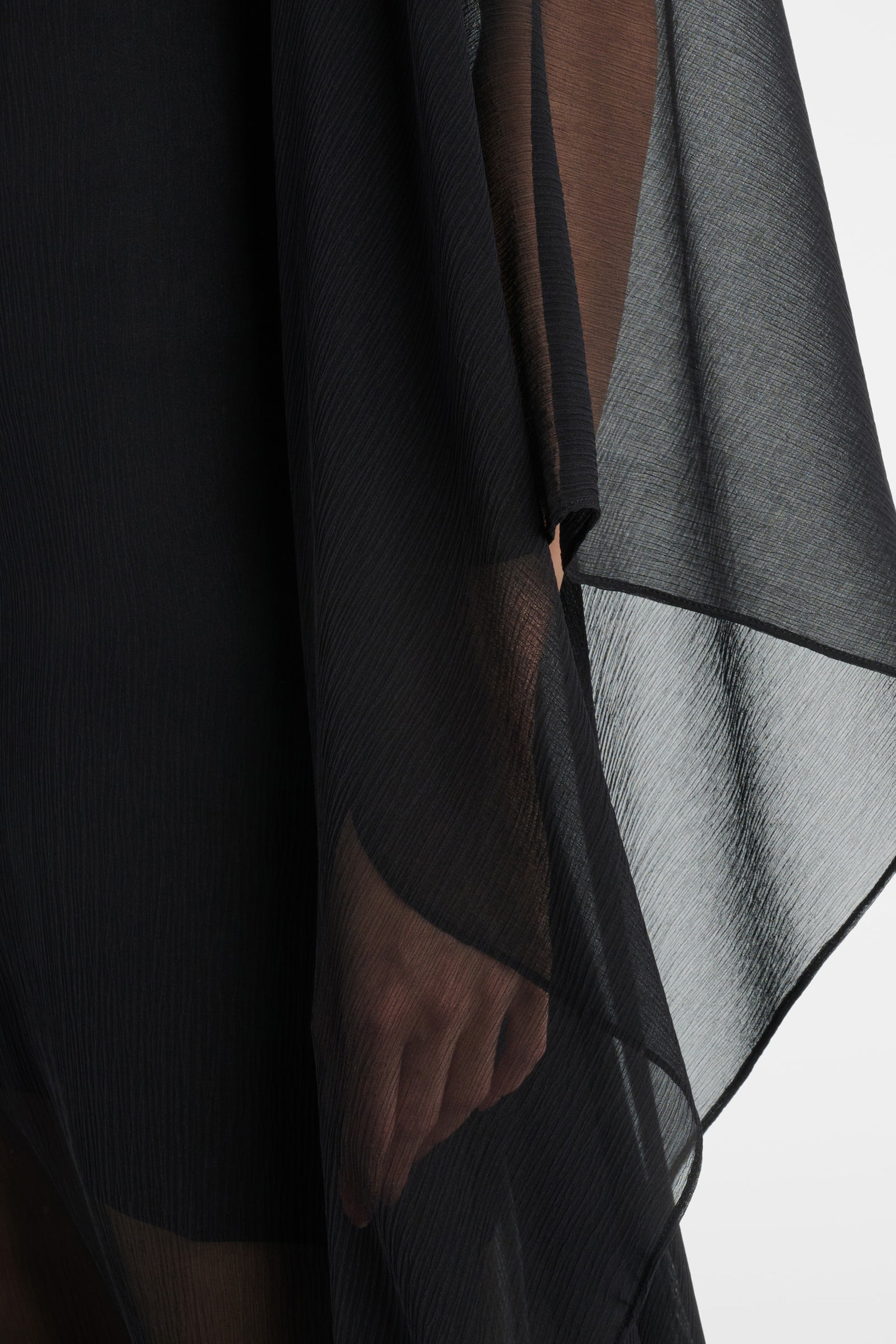 Back view of black sheer chiffon overlay gown showing closure detail