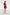 Back view of model wearing ruffled scarlet mini dress, with beige heels and clutch.