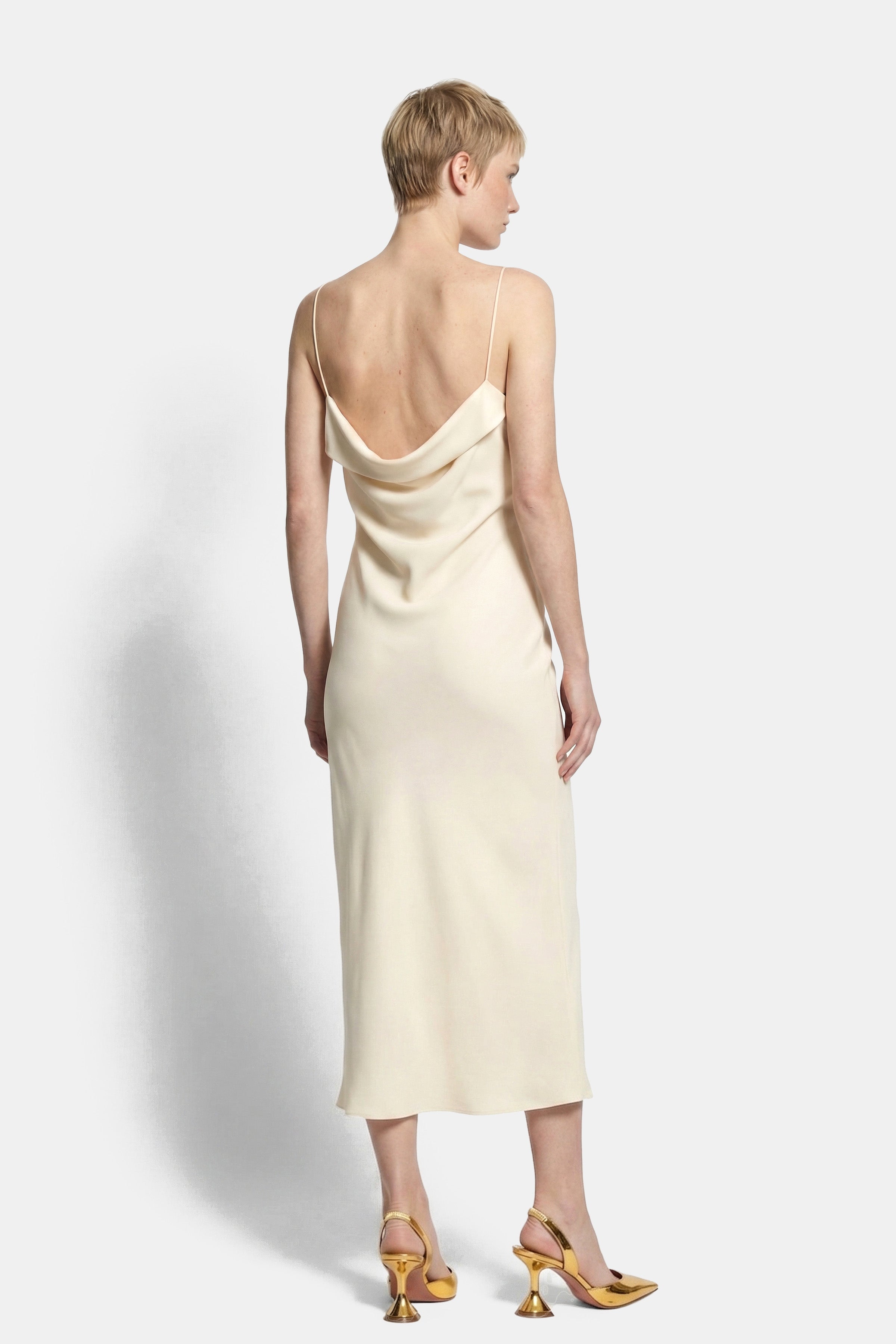 Back view of silk slip dress with a cowl neck and spaghetti straps.