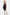 Model in black sweetheart neckline dress, front view, ruffled detail, holding clutch.