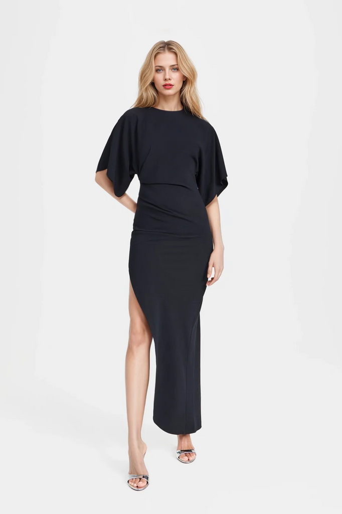 Jade Asymmetric Long Dress in black with thigh-high side slit and pleated waist.