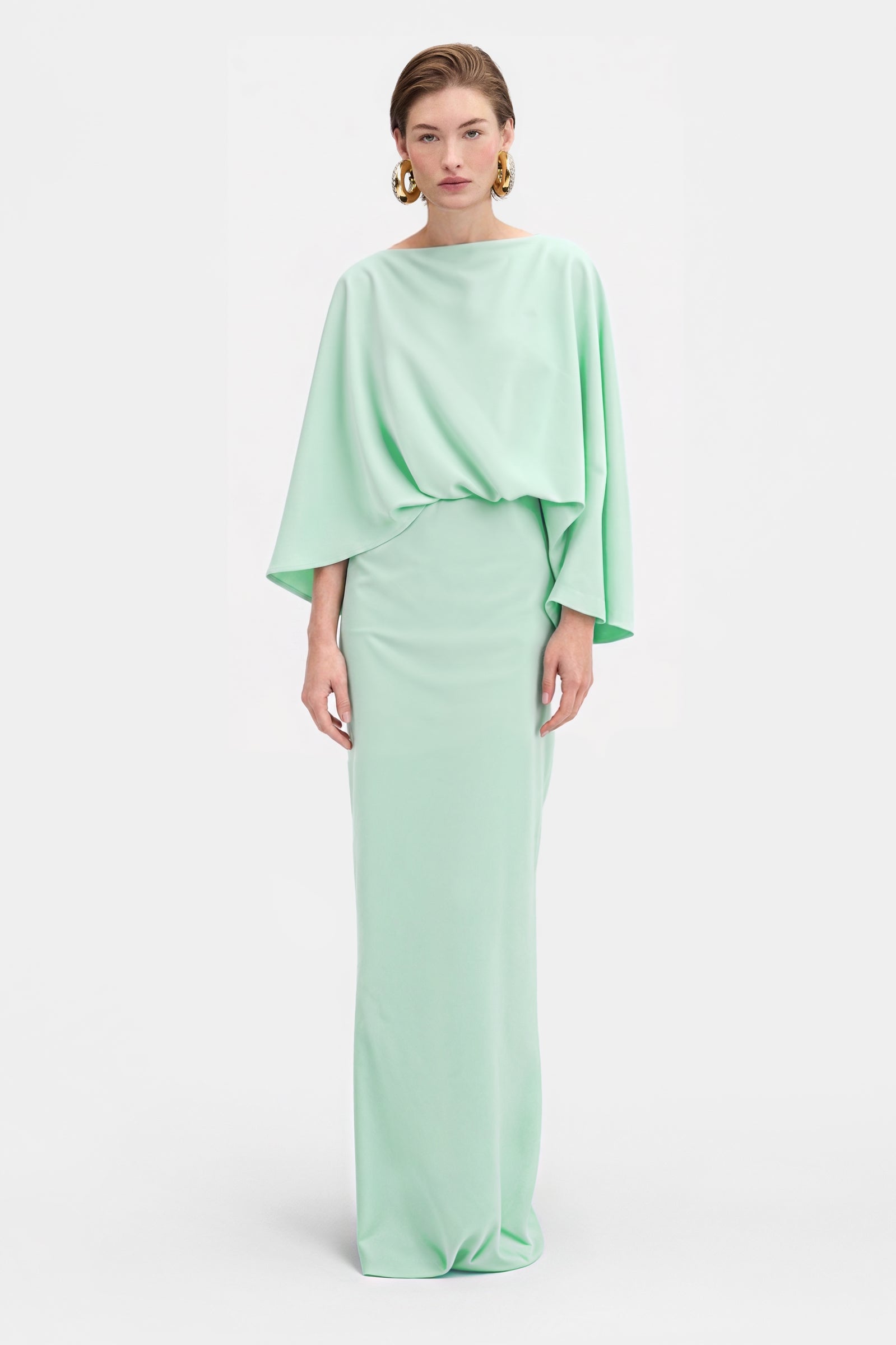 Elegant green draped dress with sculptural top and flowing maxi skirt front view