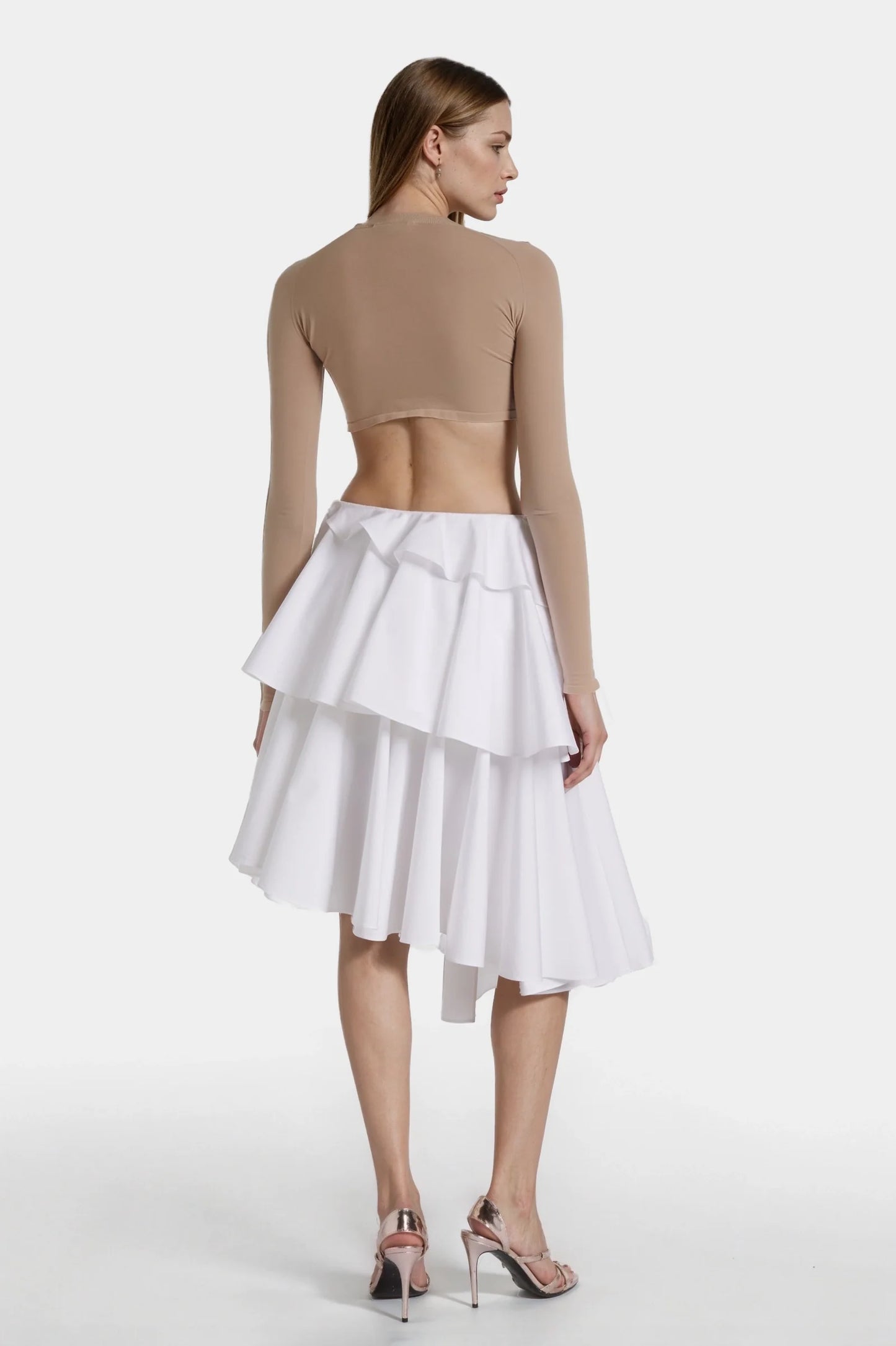 Side view showing wrap-around ruffles and angled hem of the skirt