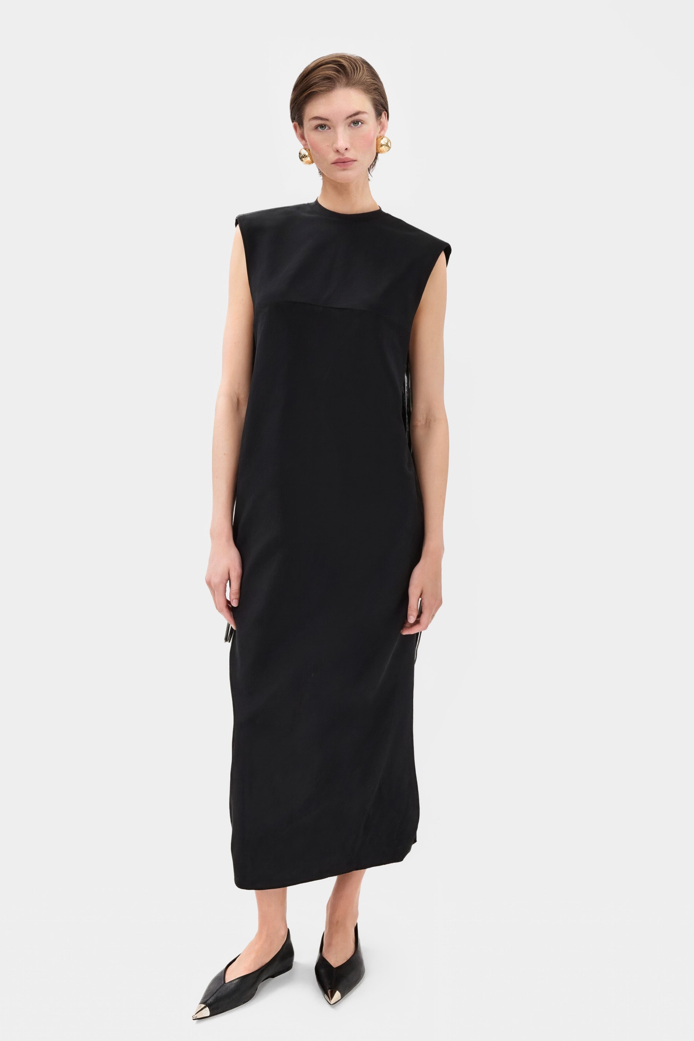 Elegant black midi dresses featuring a round neckline and on-seam hip pockets.