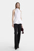 Front view of a sculptural white halter top with peplum-inspired volume.