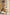 Model walking confidently in beige classic belted trench coat on city street