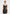 Model wearing black leather mini dress with bold ruffle detail